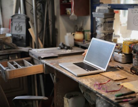 Laptop on table in workshop trying to design your Brand Kit