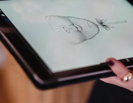 A digital drawing of a face on a tablet