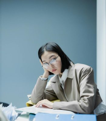 Woman in Blazer Wearing Eyeglasses Sitting at Table thinking about which file format is best