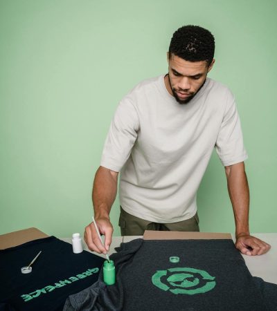 pexels-photo-9324380Custom t-shirts logos being painted on a black t-shirt with green paint Custom t-shirts logos being painted on a black t-shirt with green paint
