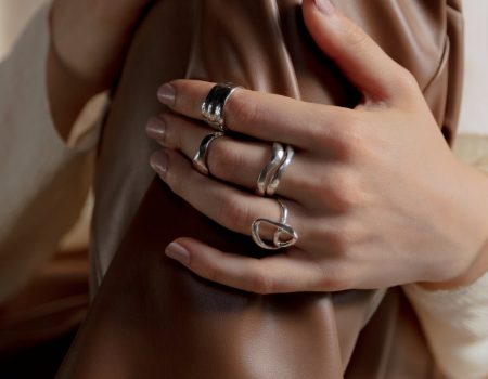 Silver rings on a female hand. The allure of silver is easily seen in silver jewlry.