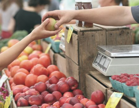 Selling apples at at Farmer's market. To start your own produce for the farming industry is rewarding but you need passion and a lot of creativity.