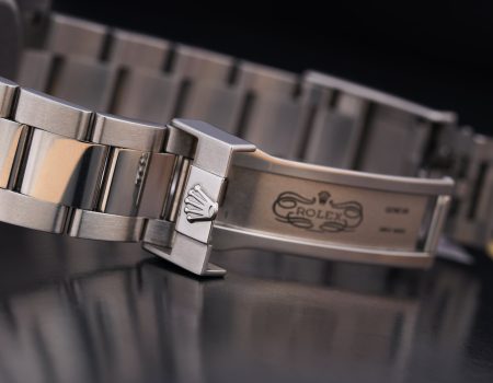 The silver Rolex logo inside a watch