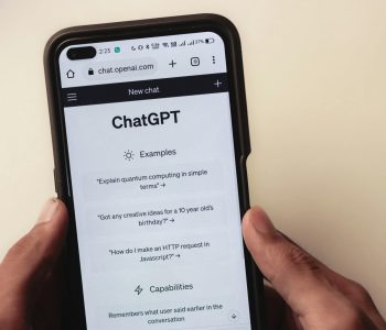 Chat GPT and logo design for AI bots.Webpage of ChatGPT, a prototype AI chatbot, is seen on the website of OpenAI, on a smartphone. Examples, capabilities, and limitations are shown.